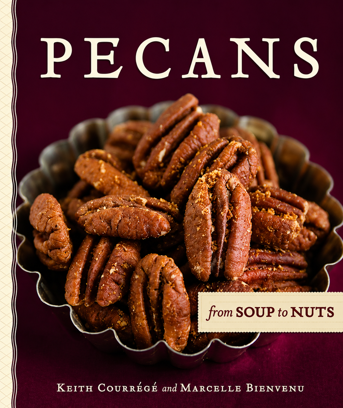 Book cover for 'Pecans from Soup to Nuts' by Keith Courrég and Marcelle Bienvenue, featuring a close-up photo of pecans in a metal bowl on a deep burgundy background. Renfroe Pecan Co. Pensacola, FL
